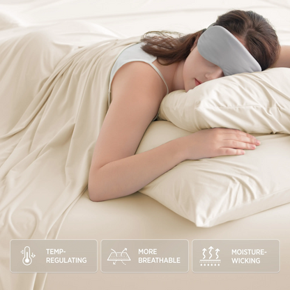 Woman with grey eye mask sleeps on ivory Breescape cooling sheets. Features: Temp-regulating, breathable, moisture-wicking.
