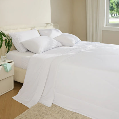 Breescape white cooling sheet set with pillows and comforter on a bed, ideal for hot sleepers.